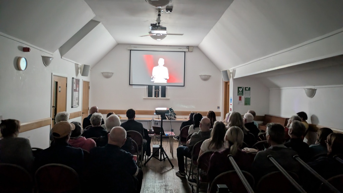 Cheam residents watch the People's Emergency Briefing in St Dunstan's Church Hall